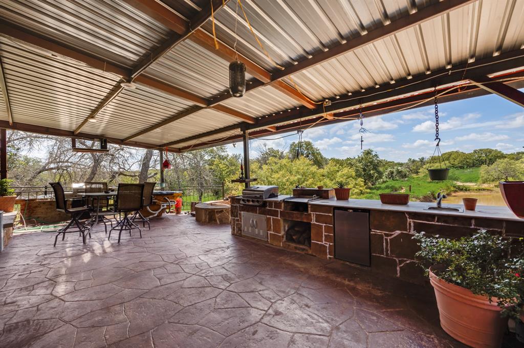 2277 County Road 3657 Springtown, TX 76082 - Photo 39 of 40 a view of a patio with table and chairs