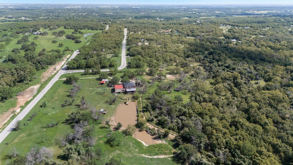 2277 County Road 3657 Springtown, TX 76082 - Photo 4 of 40 an aerial view of residential houses with outdoor space and trees