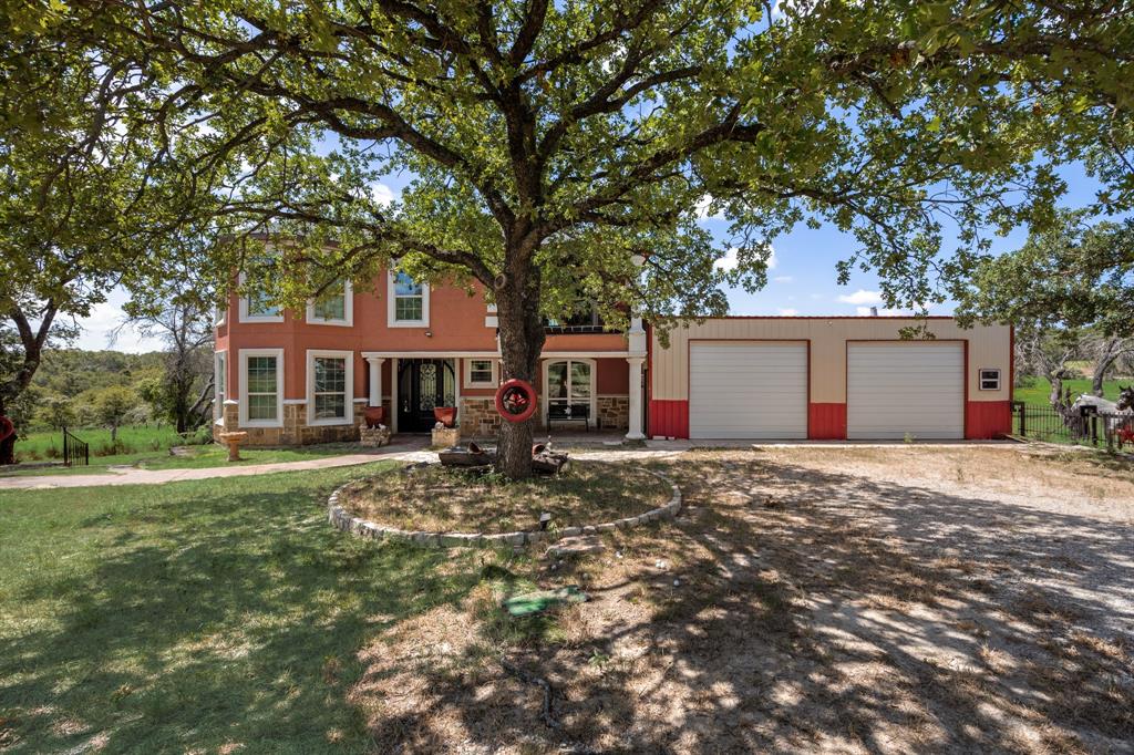 2277 County Road 3657 Springtown, TX 76082 - Photo 10 of 40 a front view of a house with a garden