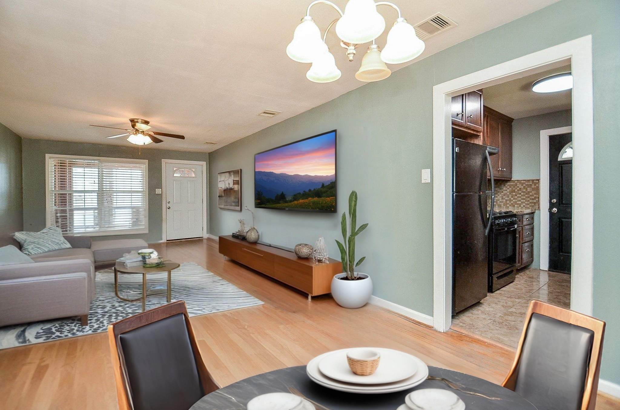 7707 Scanlock Street Houston, TX 77012 - Photo 1 of 19 a living room with furniture and a flat screen tv