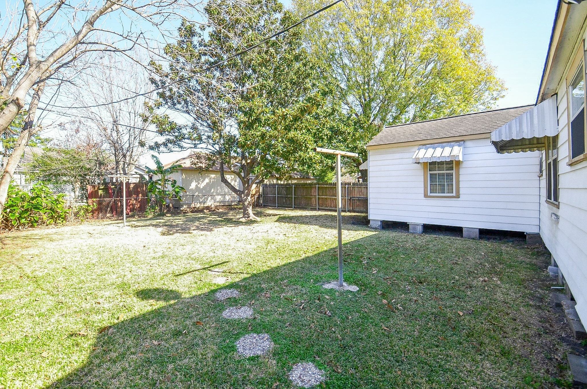 7707 Scanlock Street Houston, TX 77012 - Photo 16 of 19 a view of backyard of house with green space