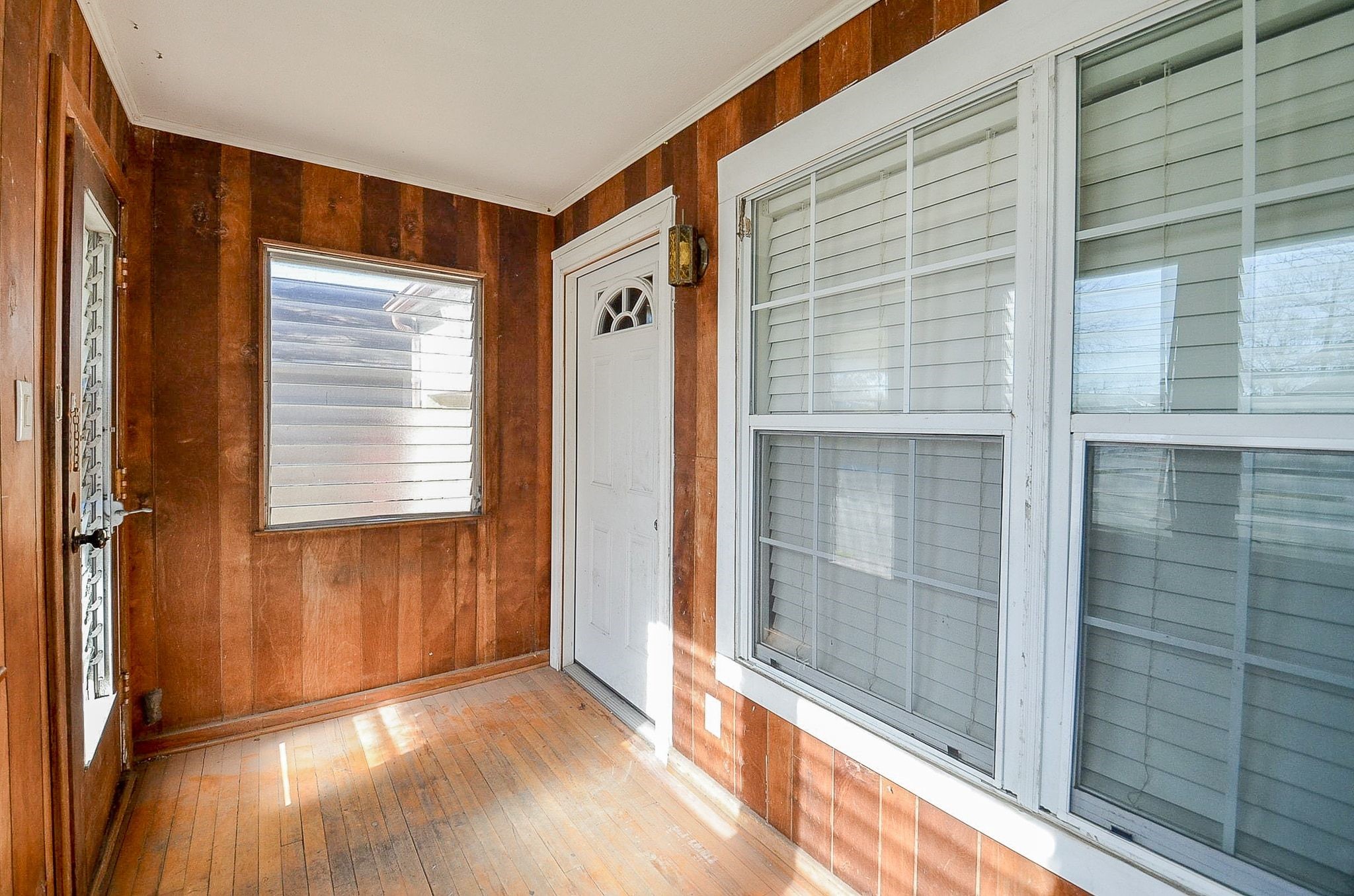 7707 Scanlock Street Houston, TX 77012 - Photo 6 of 19 a view of an empty room with wooden floor and a window