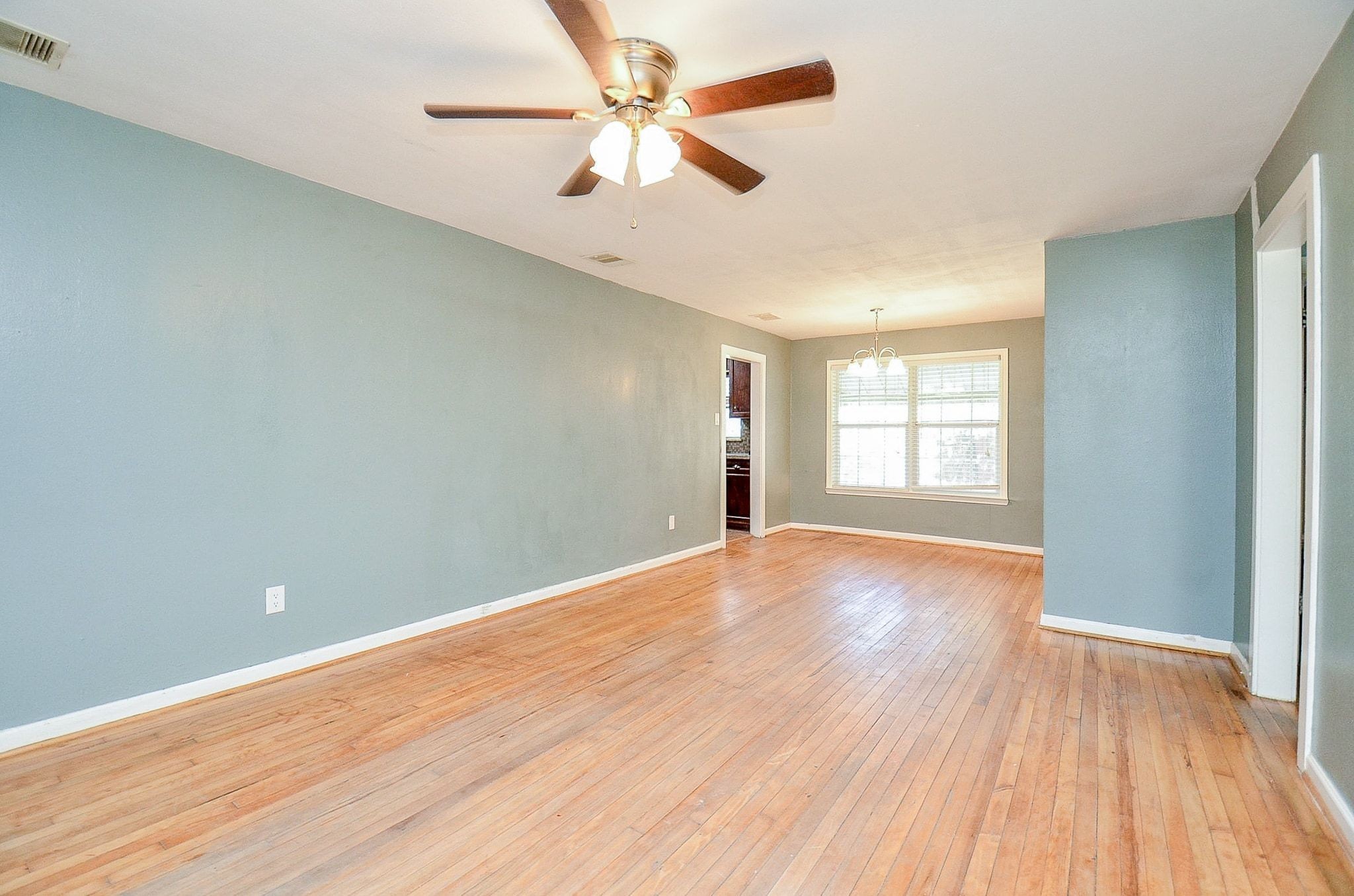 7707 Scanlock Street Houston, TX 77012 - Photo 10 of 19 an empty room with wooden floor and windows