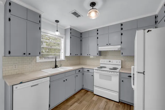 a kitchen with a white cabinets and white appliances
