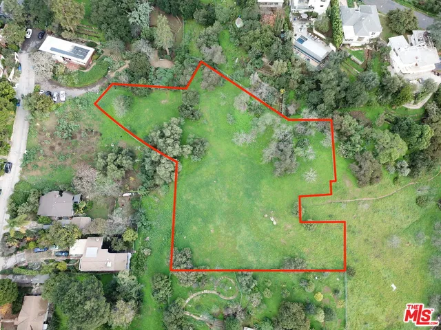 an aerial view of a houses with outdoor space and street view