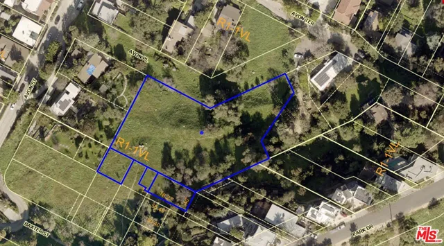 an aerial view of house with yard and mountain view in back