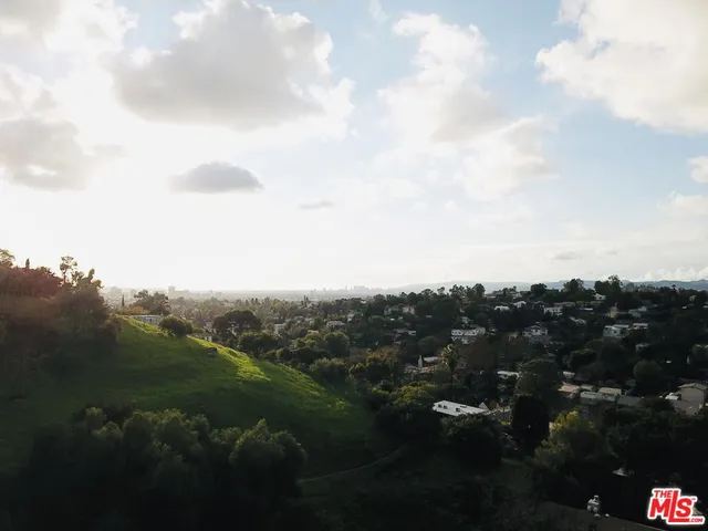 an aerial view of residential house with green space