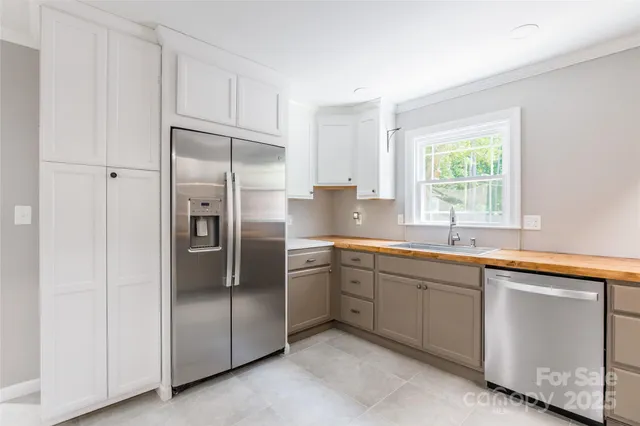 a kitchen with a refrigerator sink and cabinets