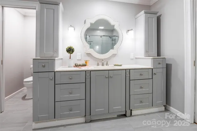 a bathroom with a double vanity sink and a mirror