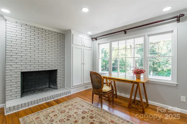 a living room with patio furniture and a fireplace