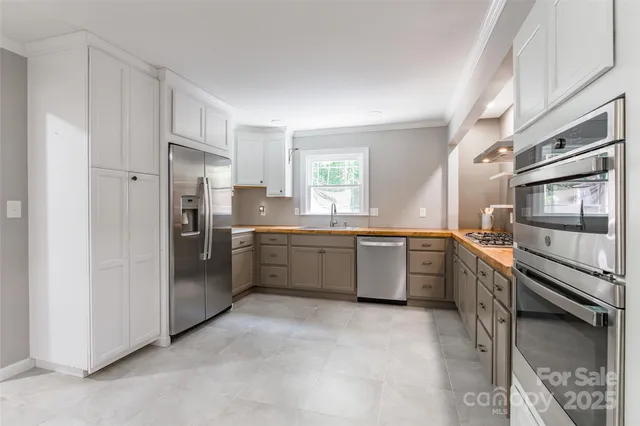 a kitchen with a sink stainless steel appliances and cabinets