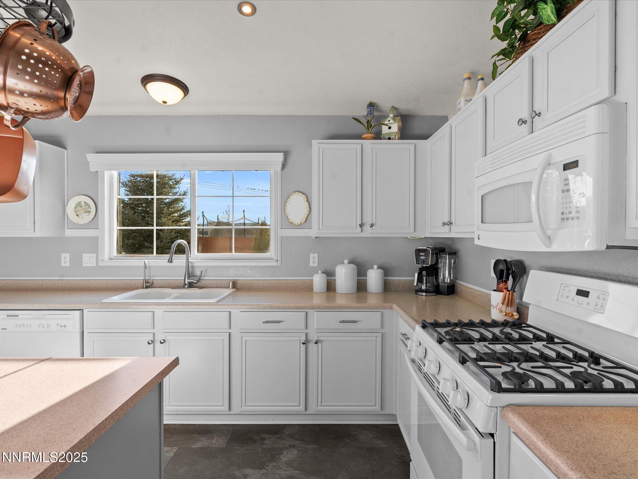 17634 Georgetown Court Reno, NV 89508 - Photo 22 of 56 a kitchen with granite countertop a sink stove and cabinets