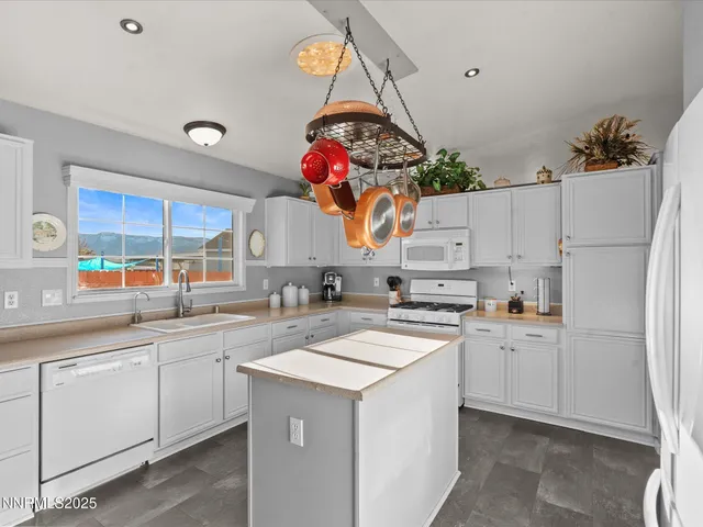 a kitchen with stainless steel appliances granite countertop a sink and cabinets