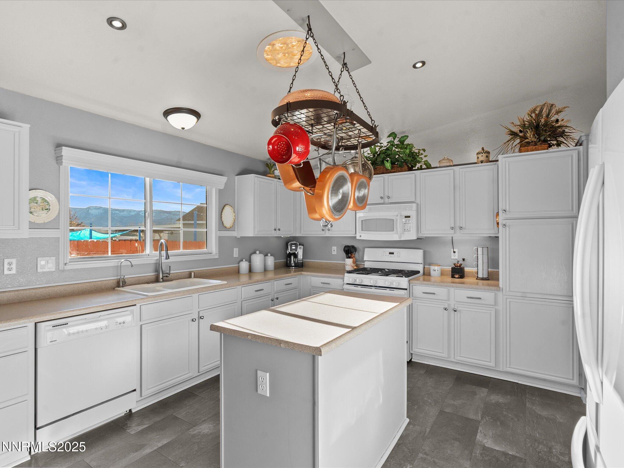 17634 Georgetown Court Reno, NV 89508 - Photo 23 of 56 a kitchen with white cabinets and white appliances