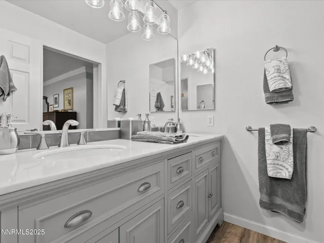 a work room with furniture a bookshelf and wooden floor