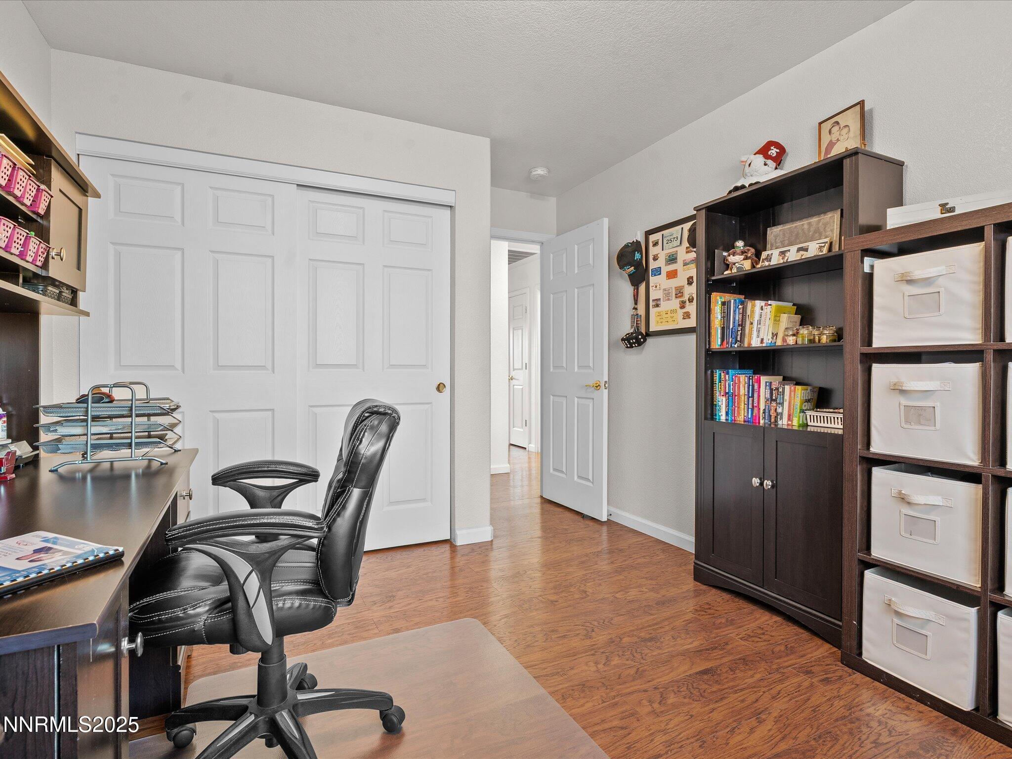 17634 Georgetown Court Reno, NV 89508 - Photo 37 of 56 a work room with furniture a bookshelf and wooden floor