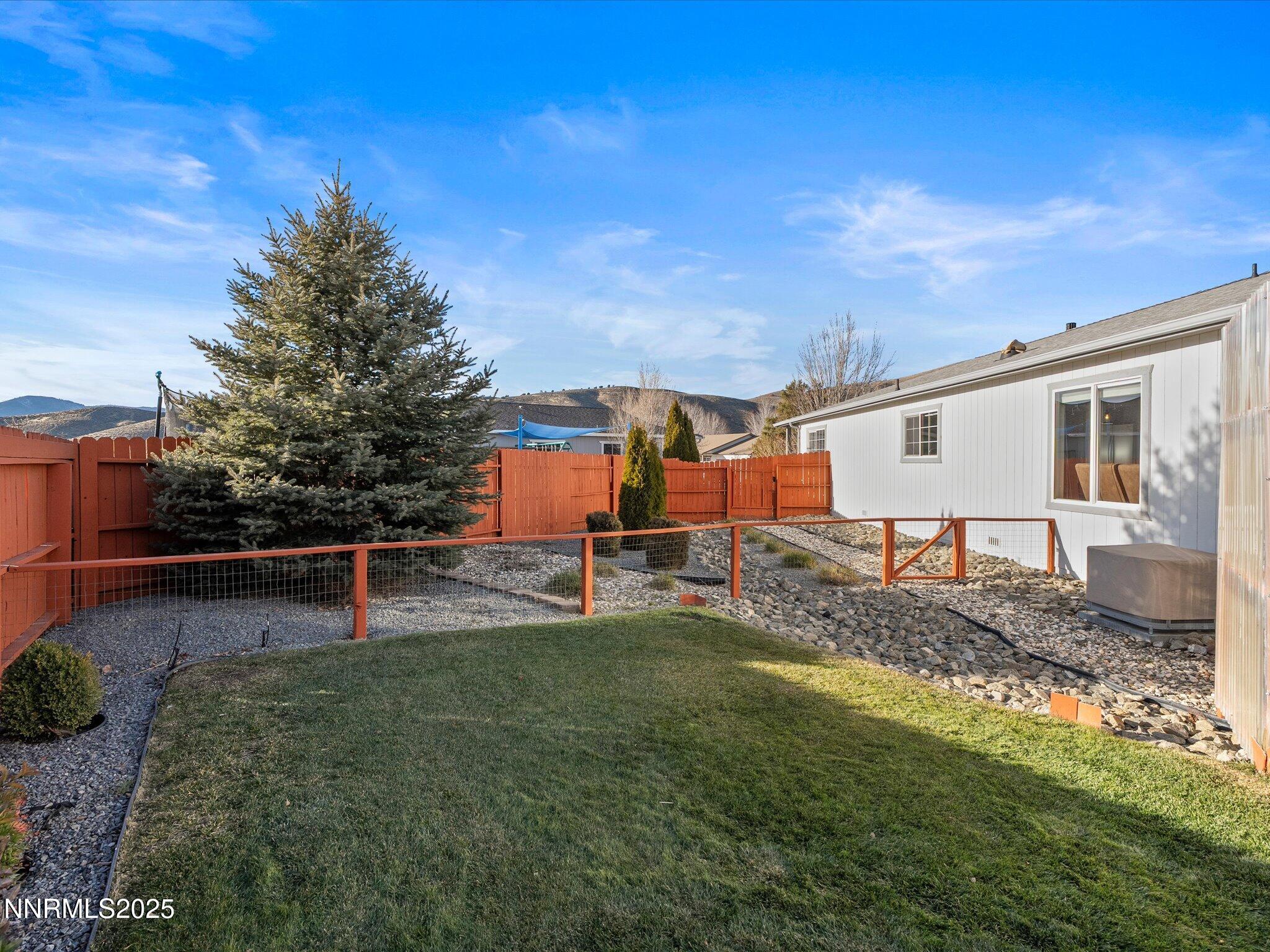 17634 Georgetown Court Reno, NV 89508 - Photo 47 of 56 a view of a backyard with couches plants and large tree