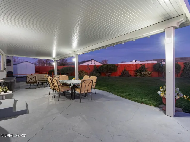 a view of a patio with a dining table and chairs