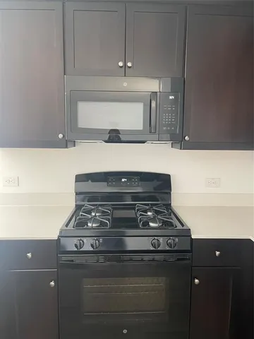 a stove top oven sitting inside of a kitchen