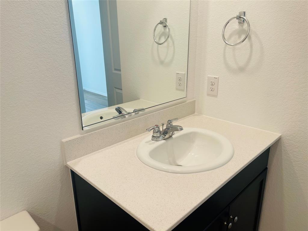 324 Red Rock Trail Haslet, TX 76052 - Photo 7 of 15 a bathroom with a sink and a mirror