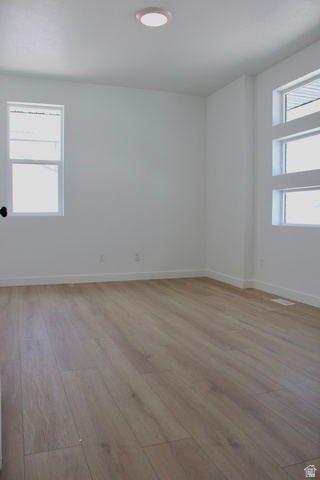 2613 Scarlet Road, Unit 258 Eagle Mountain, UT 84005 - Photo 5 of 32 Spacious room featuring light wood-finish flooring, white walls, and bright overhead lighting