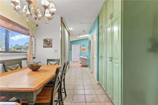 a view of a dining room with furniture and a chandelier