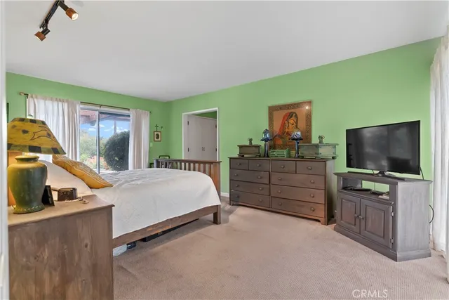 a bed room with furniture and a flat screen tv