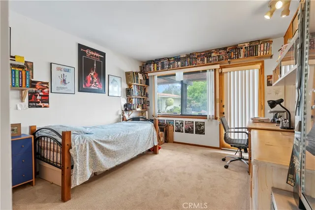 a bedroom with furniture and a window