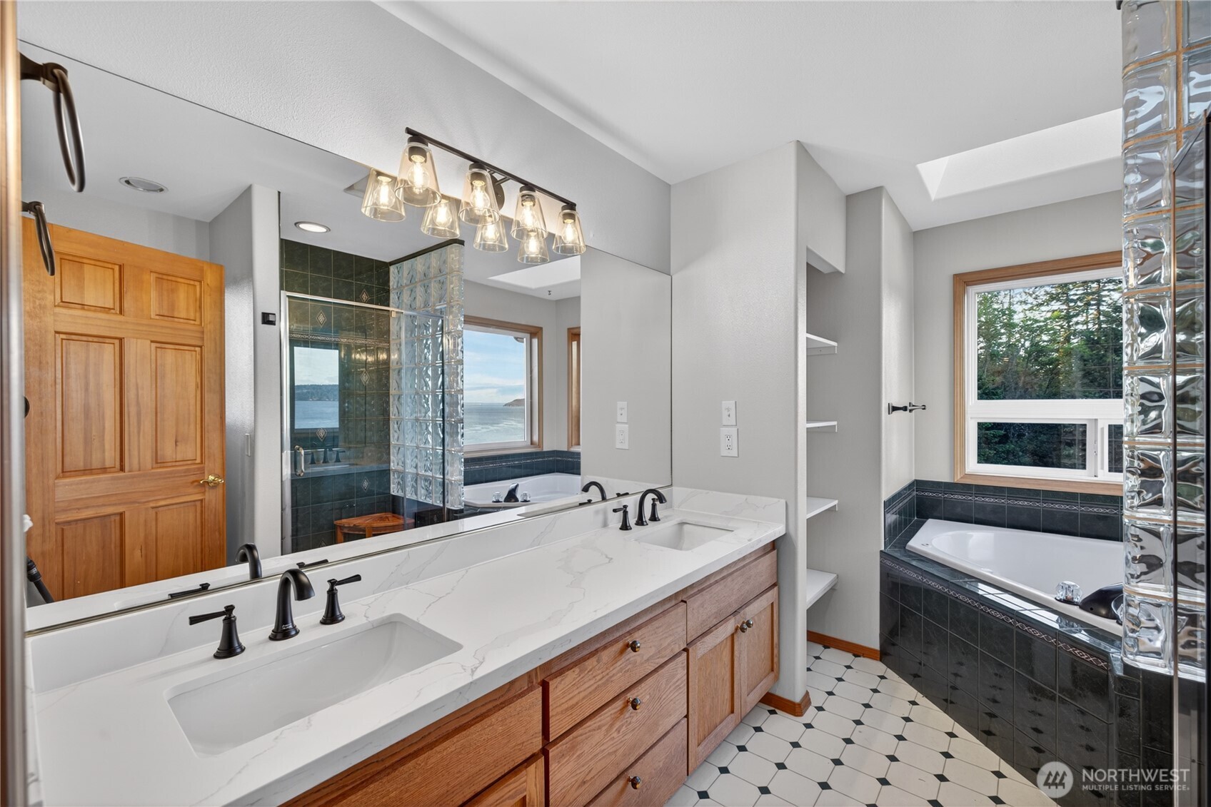 4623 Guemes Island Road Anacortes, WA 98221 - Photo 16 of 40 a bathroom with a sink double vanity and a bathtub