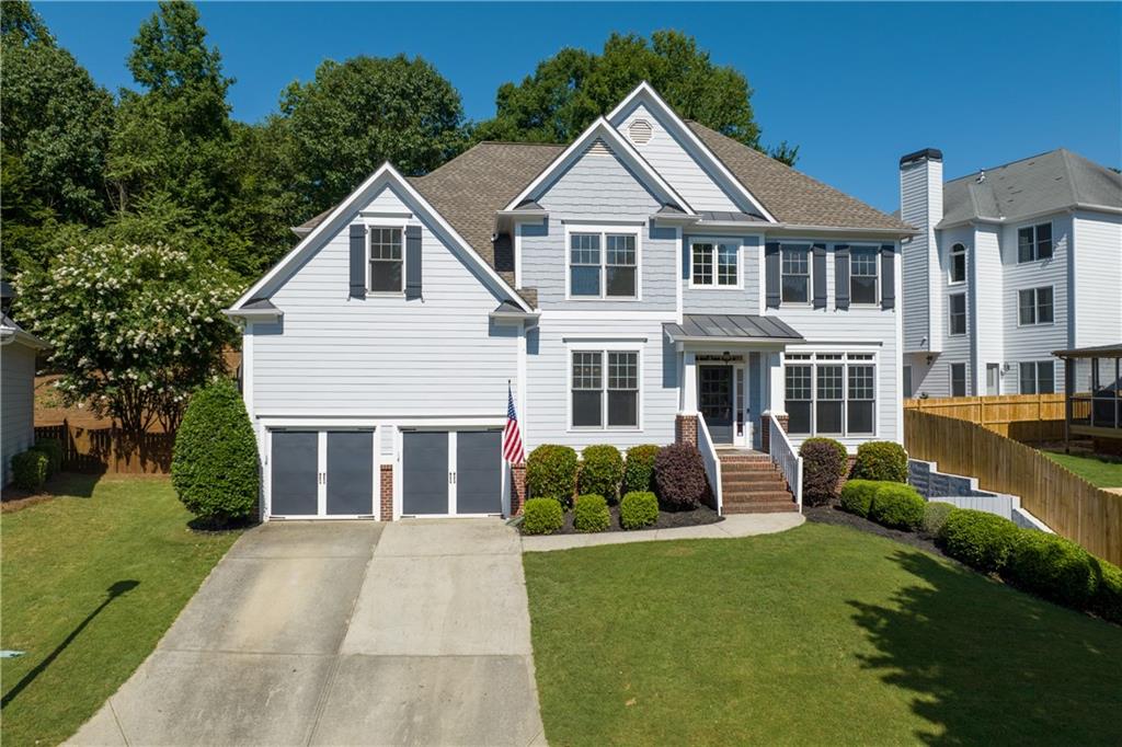 998 Poplar Mill Court Northeast Buford, GA 30518 - Photo 1 of 1 a front view of a house with garden