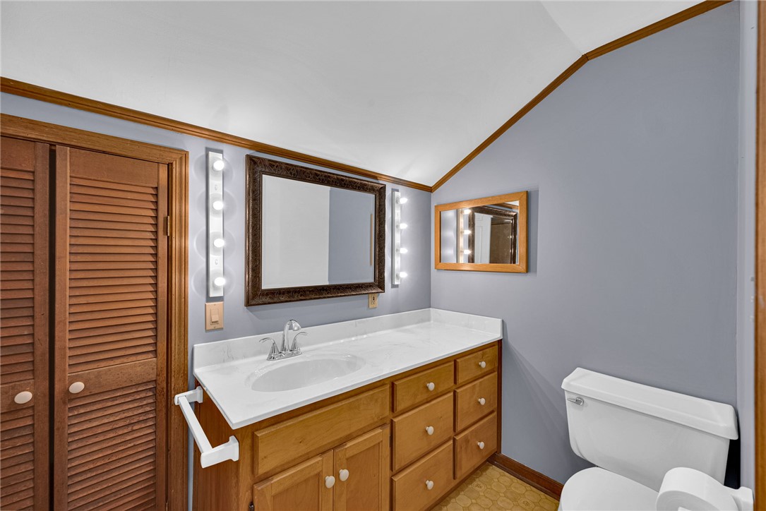 245 Cromer Road Williamston, SC 29697 - Photo 16 of 27 This bathroom features a single vanity, a toilet, and two mirrors enhancing the bright and practical space.