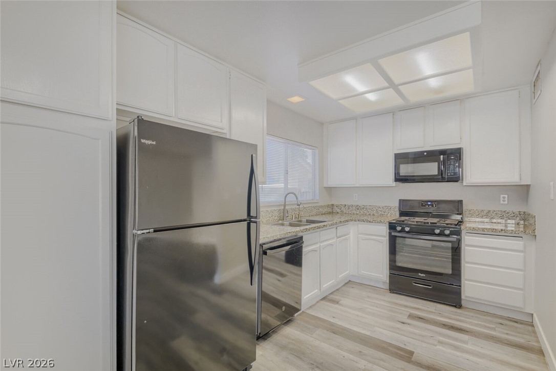 2343 Valleywood Road Henderson, NV 89014 - Photo 17 of 29 Culinary delights await in this bright kitchen, complete with ample counter space and modern appliances.