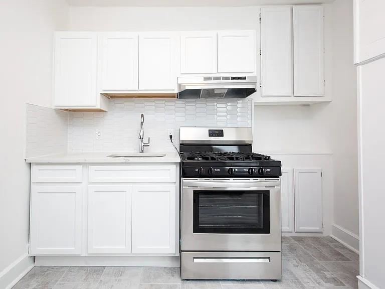 733 Hudson Avenue, Unit 2 Secaucus, NJ 07094 - Photo 2 of 13 a kitchen with stainless steel appliances granite countertop white cabinets and a stove