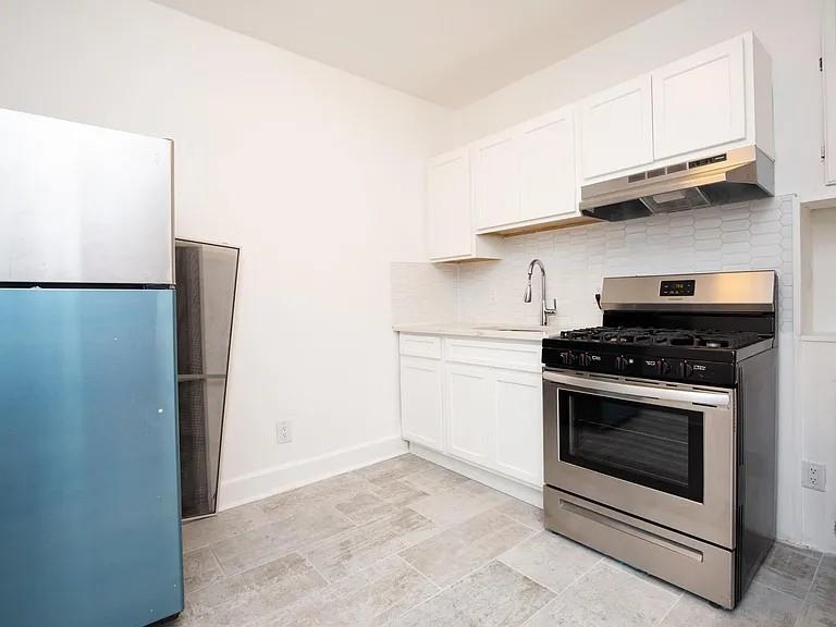 733 Hudson Avenue, Unit 2 Secaucus, NJ 07094 - Photo 3 of 13 a kitchen with stainless steel appliances white cabinets and a stove