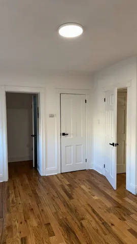 a view of a room with wooden floor