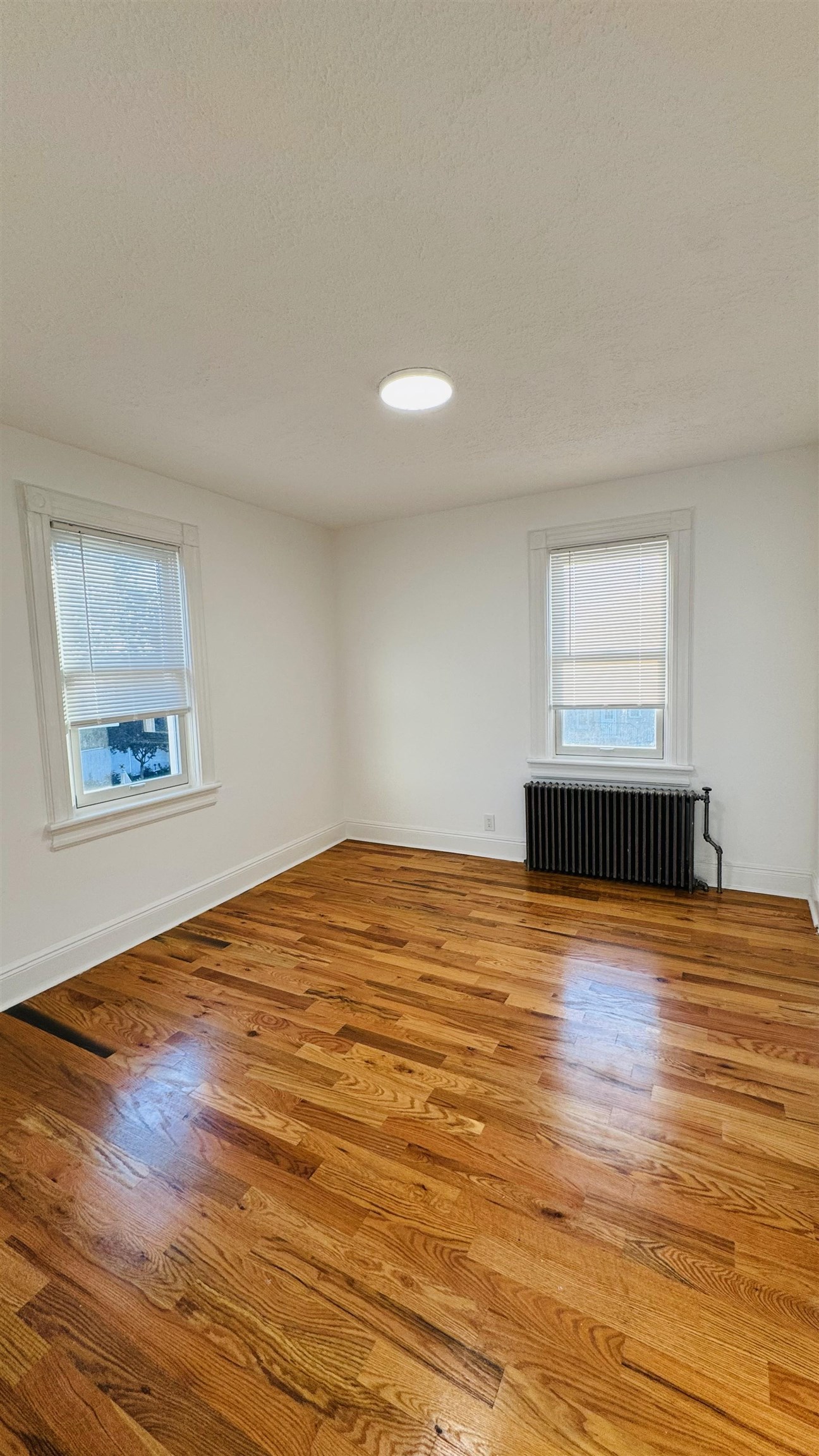 733 Hudson Avenue, Unit 2 Secaucus, NJ 07094 - Photo 10 of 13 a view of empty room with wooden floor and fan