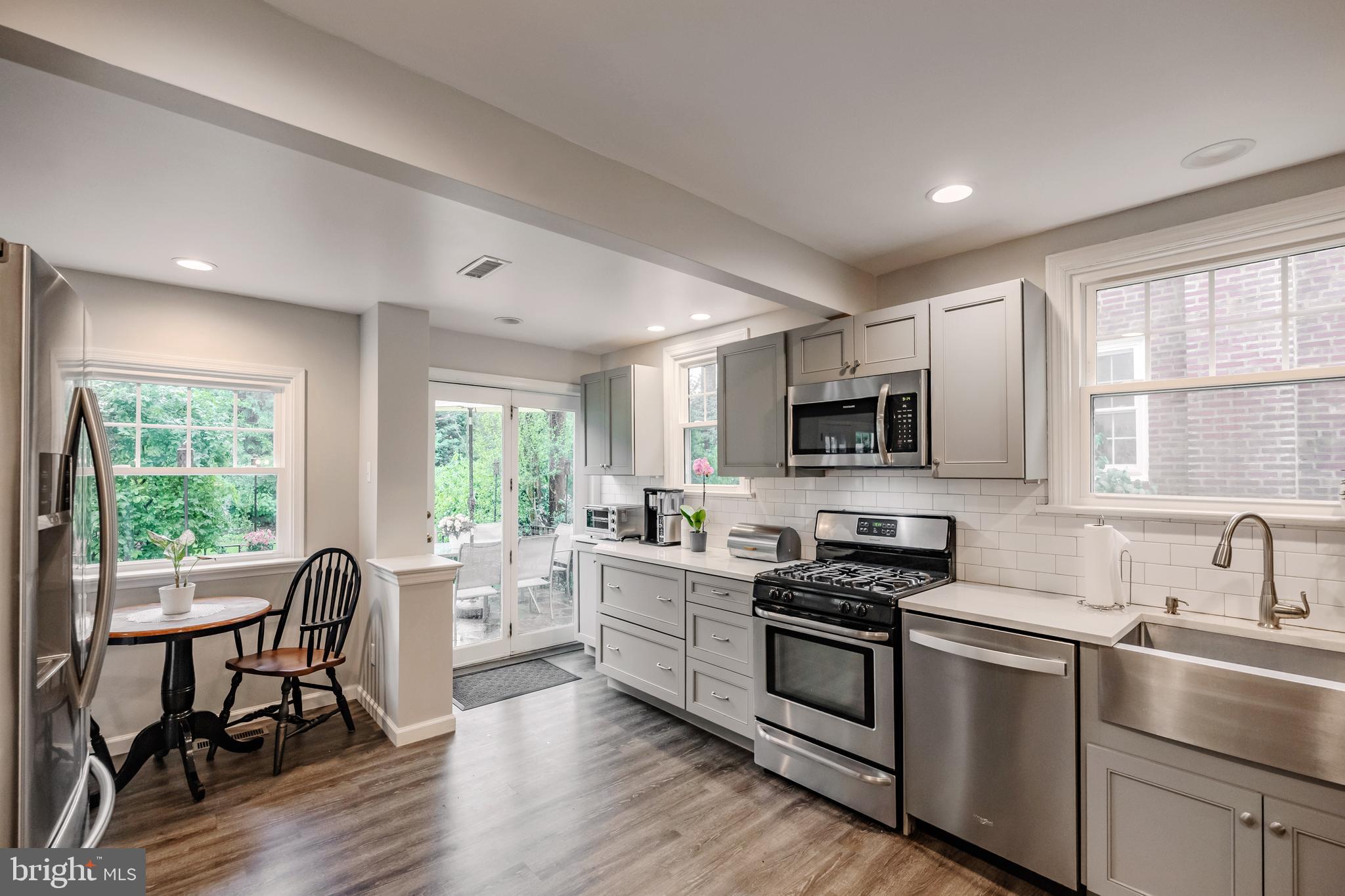 2710 Prescott Road Havertown, PA 19083 - Photo 12 of 38 a kitchen with stainless steel appliances granite countertop a stove top oven a sink dishwasher a dining table and chairs with wooden floor