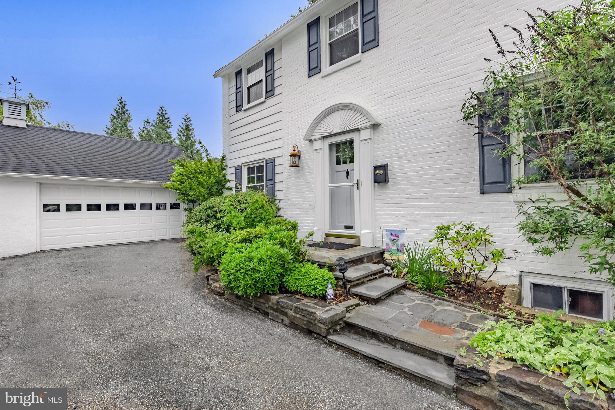 2710 Prescott Road Havertown, PA 19083 - Photo 3 of 38 a view of a house with potted plants and a bench