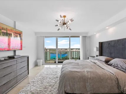 a view of a bedroom with a large bed and a window