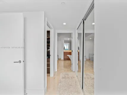 a spacious bedroom with a bed and a window