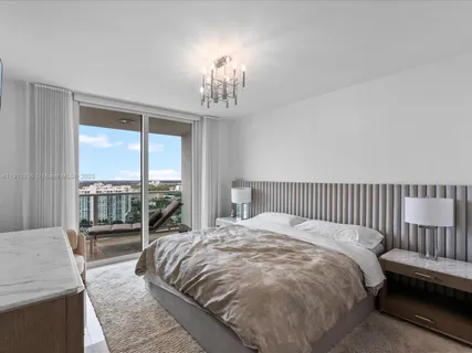 a large bed sitting in a bedroom next to a window