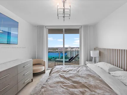 a spacious bedroom with a bed and a window