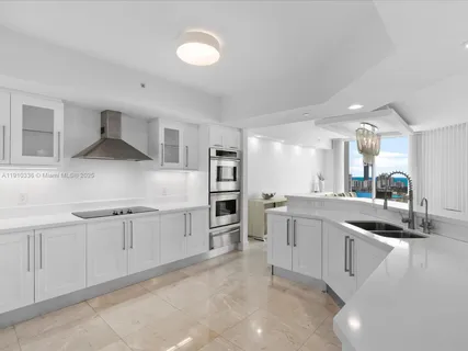 a kitchen with granite countertop a sink and stove