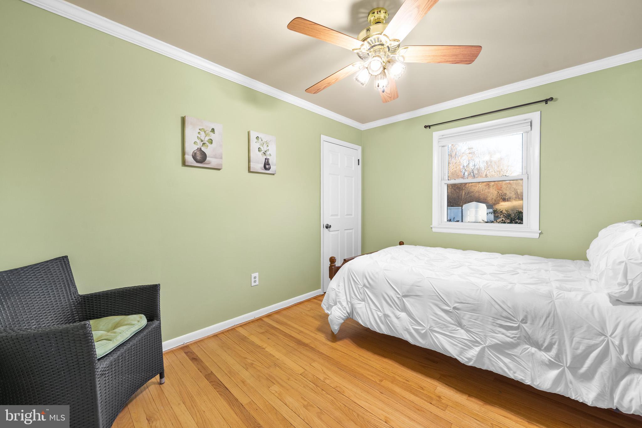 6159 Solomons Island Road Tracys Landing, MD 20779 - Photo 27 of 65 a bedroom with a large bed and a window