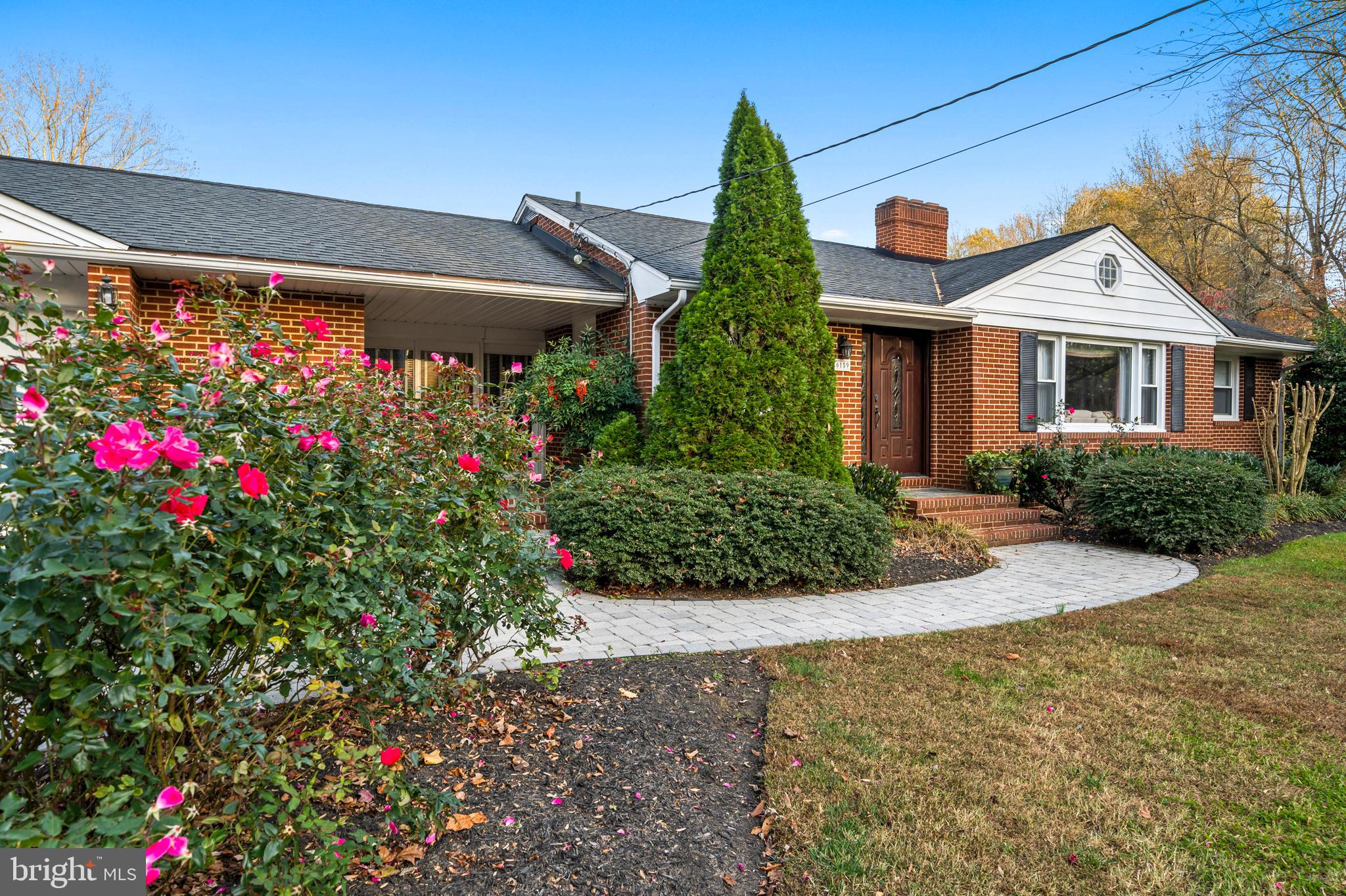 6159 Solomons Island Road Tracys Landing, MD 20779 - Photo 3 of 65 a front view of house with flowers