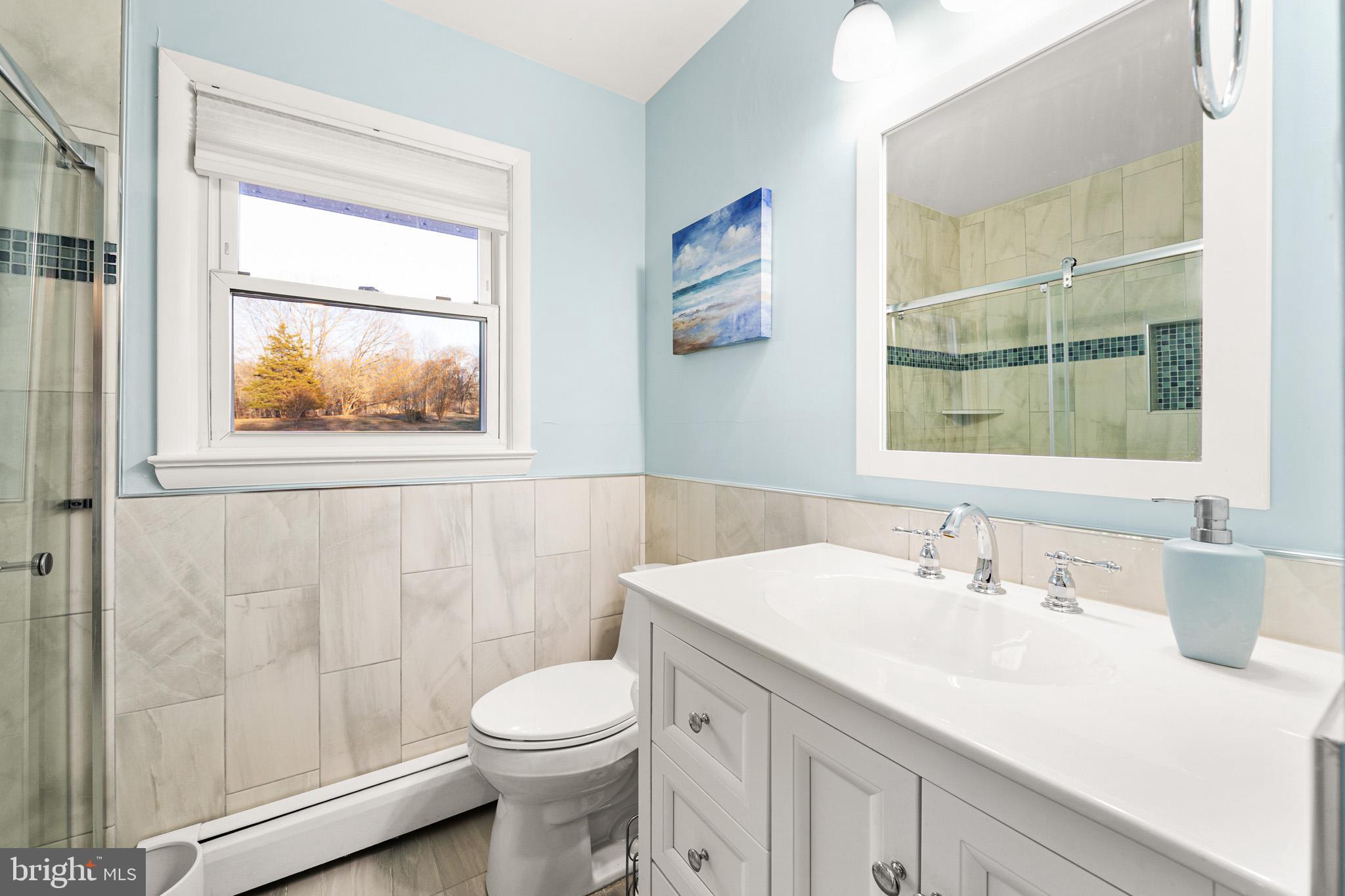 6159 Solomons Island Road Tracys Landing, MD 20779 - Photo 31 of 65 a bathroom with a sink a toilet and a window
