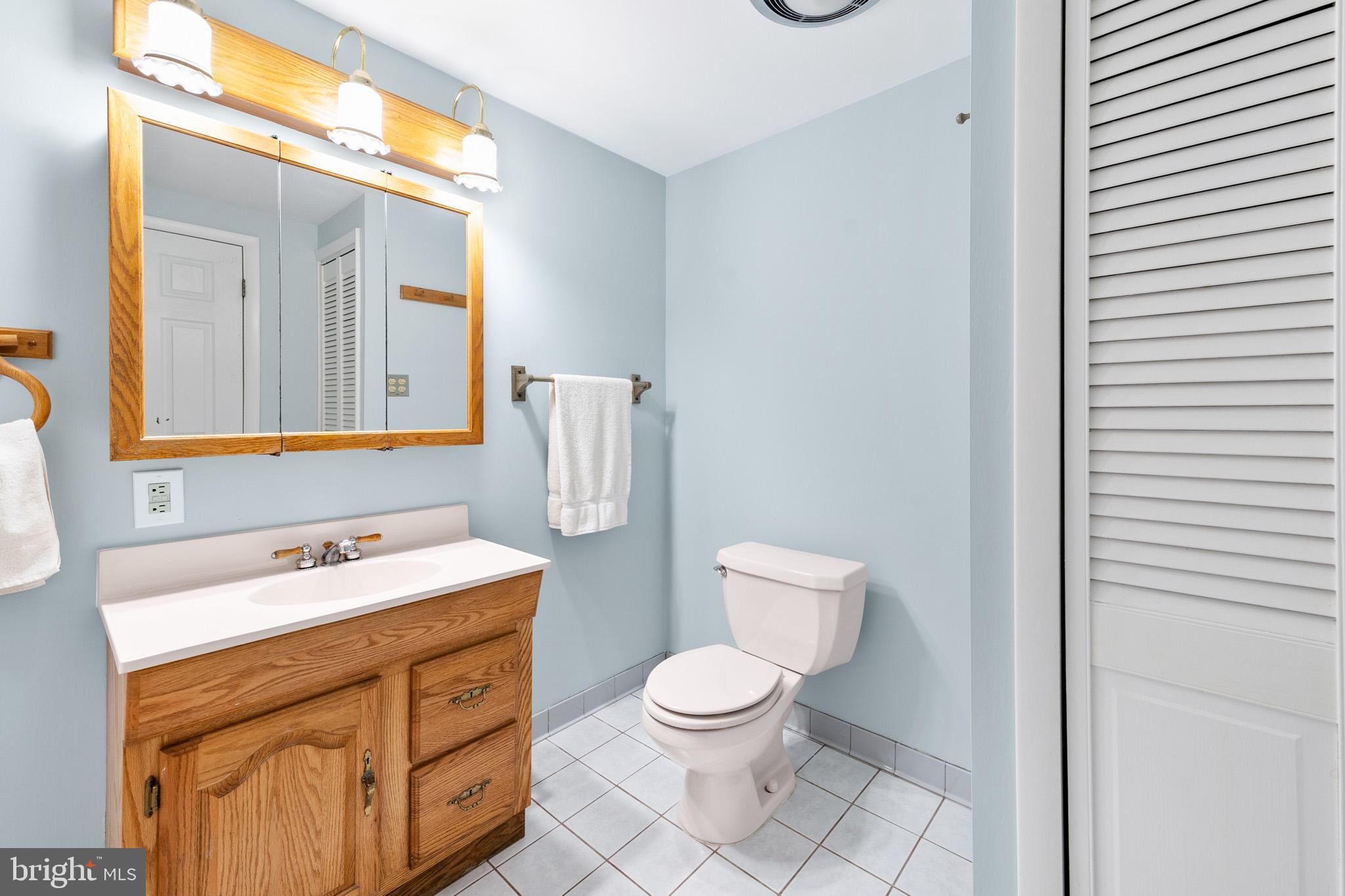 6159 Solomons Island Road Tracys Landing, MD 20779 - Photo 45 of 65 a bathroom with a toilet sink and mirror