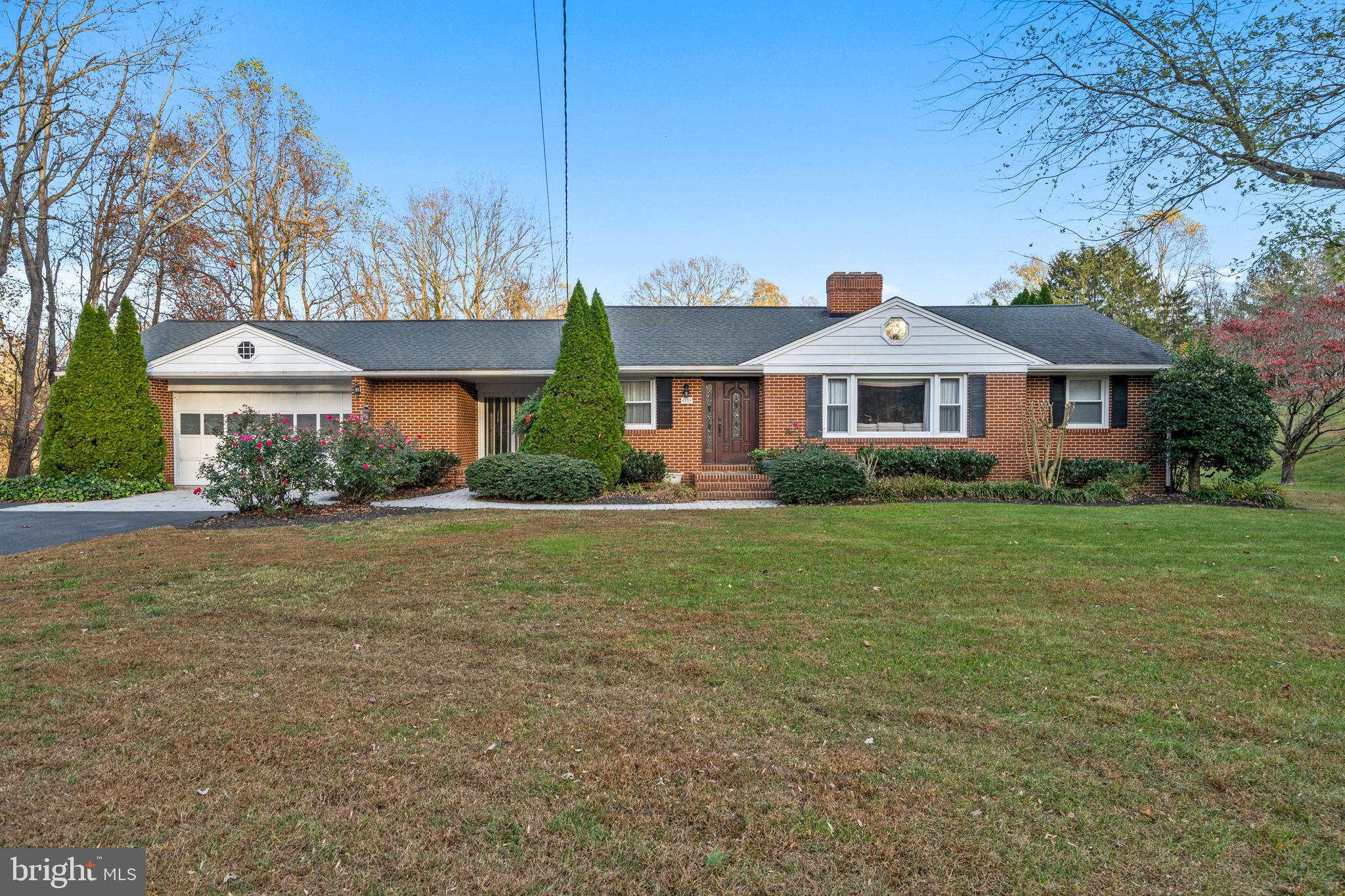 6159 Solomons Island Road Tracys Landing, MD 20779 - Photo 56 of 65 a front view of a house with garden