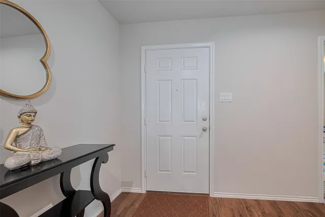 a very nice looking room with a mirror and a wooden door