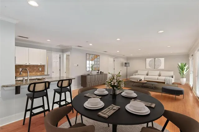 a view of a dining room with furniture and wooden floor